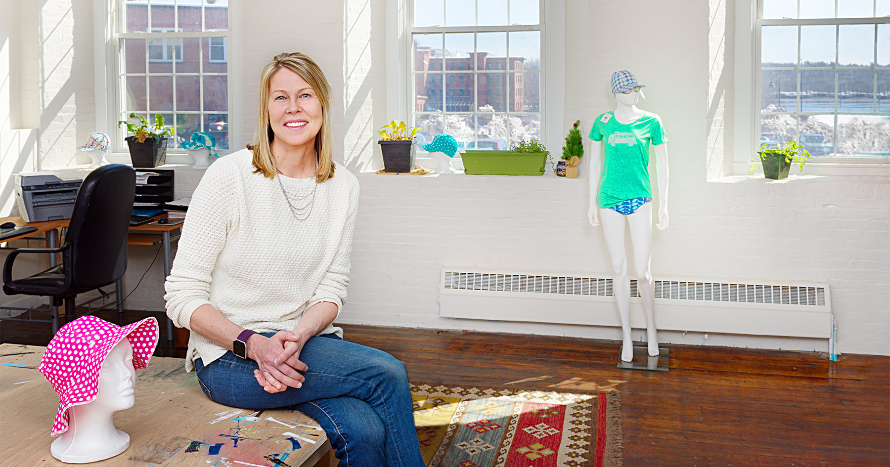 Karen Gellis, owner of Swimlids, stops for a brief moment in her studio at the Pepperell Mill Campus to be photographed by Portland Headshot.